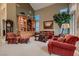 Elegant living room features a display cabinet, tall ceilings, and plentiful, comfortable seating at 3042 Hammerwood Dr, Las Vegas, NV 89135