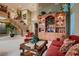 Spacious living room boasts a grand staircase, hardwood display case, and elegant furniture at 3042 Hammerwood Dr, Las Vegas, NV 89135