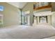 Spacious living room featuring soaring ceilings, large windows, and neutral carpeting at 3042 Hammerwood Dr, Las Vegas, NV 89135