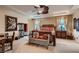 Elegant main bedroom featuring a ceiling fan, cozy sitting area, and neutral decor at 3042 Hammerwood Dr, Las Vegas, NV 89135