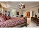 Bright main bedroom with large bed, decorative ceiling fan, and an open layout at 3042 Hammerwood Dr, Las Vegas, NV 89135