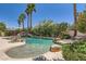 Inviting backyard pool area with lush landscaping, a rock waterfall, and a cozy tiki hut at 3042 Hammerwood Dr, Las Vegas, NV 89135