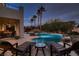 Backyard pool with lounge chairs, tiki hut, and well-manicured landscaping at 3042 Hammerwood Dr, Las Vegas, NV 89135