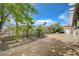 Tile patio and landscaped backyard with mature trees, offering a serene outdoor retreat at 3192 Tullio Way, Henderson, NV 89052