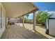A spacious covered patio with tiled flooring and an expansive yard filled with greenery at 3192 Tullio Way, Henderson, NV 89052