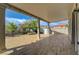 Expansive covered patio with tiled flooring overlooking a lush yard with flowering trees at 3192 Tullio Way, Henderson, NV 89052