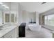 Bright bathroom featuring a modern freestanding tub, white cabinetry, and elegant countertops at 3192 Tullio Way, Henderson, NV 89052