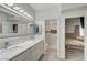 Bathroom with double sinks and a large mirror at 3192 Tullio Way, Henderson, NV 89052