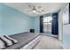 Bedroom with blue walls and a large window with decorative curtains at 3192 Tullio Way, Henderson, NV 89052