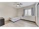 Bedroom with wood-look flooring, a ceiling fan, and a large window for natural light at 3192 Tullio Way, Henderson, NV 89052