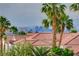 Stunning Las Vegas skyline views, complemented by lush palm trees and a neighborhood of red tiled roofs at 3192 Tullio Way, Henderson, NV 89052