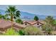 A stunning cityscape vista with palm trees, landscaping, and red tiled roofs at 3192 Tullio Way, Henderson, NV 89052