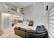 Bright living room features soaring ceilings, tile floors, and a large sofa at 3192 Tullio Way, Henderson, NV 89052