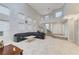 Expansive living room with spiral staircase, tile floors, and a large leather sectional sofa at 3192 Tullio Way, Henderson, NV 89052