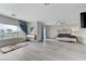 Spacious main bedroom with large window, grey wood-look floors and decorative curtains at 3192 Tullio Way, Henderson, NV 89052