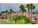 A view of the neighborhood highlighting the palm trees, tile roofs and city skyline at 3192 Tullio Way, Henderson, NV 89052
