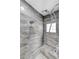 Modern tiled shower with rainfall shower head and built-in bench at 3192 Tullio Way, Henderson, NV 89052