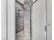 Modern tiled shower with rainfall shower head and glass door at 3192 Tullio Way, Henderson, NV 89052
