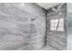 Modern tiled shower with rainfall shower head and glass block window at 3192 Tullio Way, Henderson, NV 89052