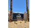 The Isle at Monaco community sign framed by twin palm trees at 3261 Monaco Shores Dr, Las Vegas, NV 89117