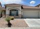 A one-story home that features desert landscaping, a two-car garage, and a tiled roof at 3261 Monaco Shores Dr, Las Vegas, NV 89117