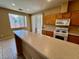 Well-lit kitchen featuring light countertops, wood cabinets, and stainless-steel appliances at 3261 Monaco Shores Dr, Las Vegas, NV 89117