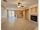 Open-concept living area boasts tiled flooring, a ceiling fan, and fireplace perfect for Gathering at 3261 Monaco Shores Dr, Las Vegas, NV 89117