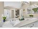 Bright bathroom with dual sinks, a large mirror, and a separate shower room at 3659 Gerri Bay Ln, Las Vegas, NV 89147