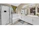 Elegant bathroom with a glass-enclosed shower, a soaking tub, and a double sink vanity at 3659 Gerri Bay Ln, Las Vegas, NV 89147