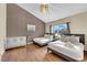 Bright bedroom with two beds, a crib and natural light from the window at 3659 Gerri Bay Ln, Las Vegas, NV 89147