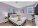 Cozy bedroom with wood floors, a comfortable bed, and natural light from the windows at 3659 Gerri Bay Ln, Las Vegas, NV 89147
