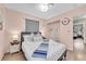 Inviting bedroom featuring stylish decor, a cozy bed, and plenty of natural light with wood laminate flooring at 3659 Gerri Bay Ln, Las Vegas, NV 89147