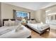 Bright bedroom featuring two beds, hardwood floors, and an en-suite bathroom with modern fixtures at 3659 Gerri Bay Ln, Las Vegas, NV 89147