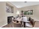 Bright dining room with a large table, seating for eight, fireplace and modern décor at 3659 Gerri Bay Ln, Las Vegas, NV 89147