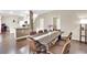 Open floor plan: dining area with wood floors, view of the kitchen, and easy access to laundry room at 3659 Gerri Bay Ln, Las Vegas, NV 89147