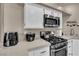 Kitchen with stainless steel appliances, white cabinetry, and granite countertops at 3659 Gerri Bay Ln, Las Vegas, NV 89147