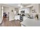 Well-lit kitchen with stainless steel appliances, white cabinetry, and wood-look flooring at 3659 Gerri Bay Ln, Las Vegas, NV 89147