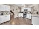 Updated kitchen boasts stainless steel appliances, white cabinets, and lots of counter space at 3659 Gerri Bay Ln, Las Vegas, NV 89147