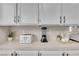 Quartz countertop with modern appliances and white cabinetry provides ample space in this kitchen at 3659 Gerri Bay Ln, Las Vegas, NV 89147