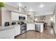 Modern kitchen with white cabinets, stainless steel appliances, and wood floors at 3659 Gerri Bay Ln, Las Vegas, NV 89147