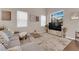Cozy living room with large windows, a plush gray sofa, and stylish decor at 3659 Gerri Bay Ln, Las Vegas, NV 89147