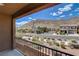 A balcony view of desert landscaping and a neighborhood street that captures mountain scenery at 3839 Zodiacal Light St, Las Vegas, NV 89129