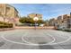 Community basketball court with hoop, surrounded by buildings and greenery, offers recreational space for residents at 3839 Zodiacal Light St, Las Vegas, NV 89129
