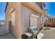 This is a side view of a home with a grill in the back yard, with closed shutters on the windows at 3839 Zodiacal Light St, Las Vegas, NV 89129
