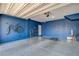 Bright blue garage with speckled floors, tools, and an overhead door, great for parking and storage at 3839 Zodiacal Light St, Las Vegas, NV 89129
