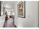 Hallway leading to the living room with hardwood floors, wall art, and ample lighting at 3839 Zodiacal Light St, Las Vegas, NV 89129