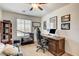 Functional home office with dark wood desk, ergonomic chair, and ample natural light at 3839 Zodiacal Light St, Las Vegas, NV 89129