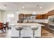 Bright kitchen featuring granite countertops, stainless steel appliances and stylish barstool seating at 3839 Zodiacal Light St, Las Vegas, NV 89129