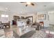 Well-lit living room seamlessly blending with a modern kitchen and dining area at 3839 Zodiacal Light St, Las Vegas, NV 89129