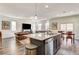 Open-concept living space featuring a modern kitchen, dining area, and leather sofas at 3839 Zodiacal Light St, Las Vegas, NV 89129